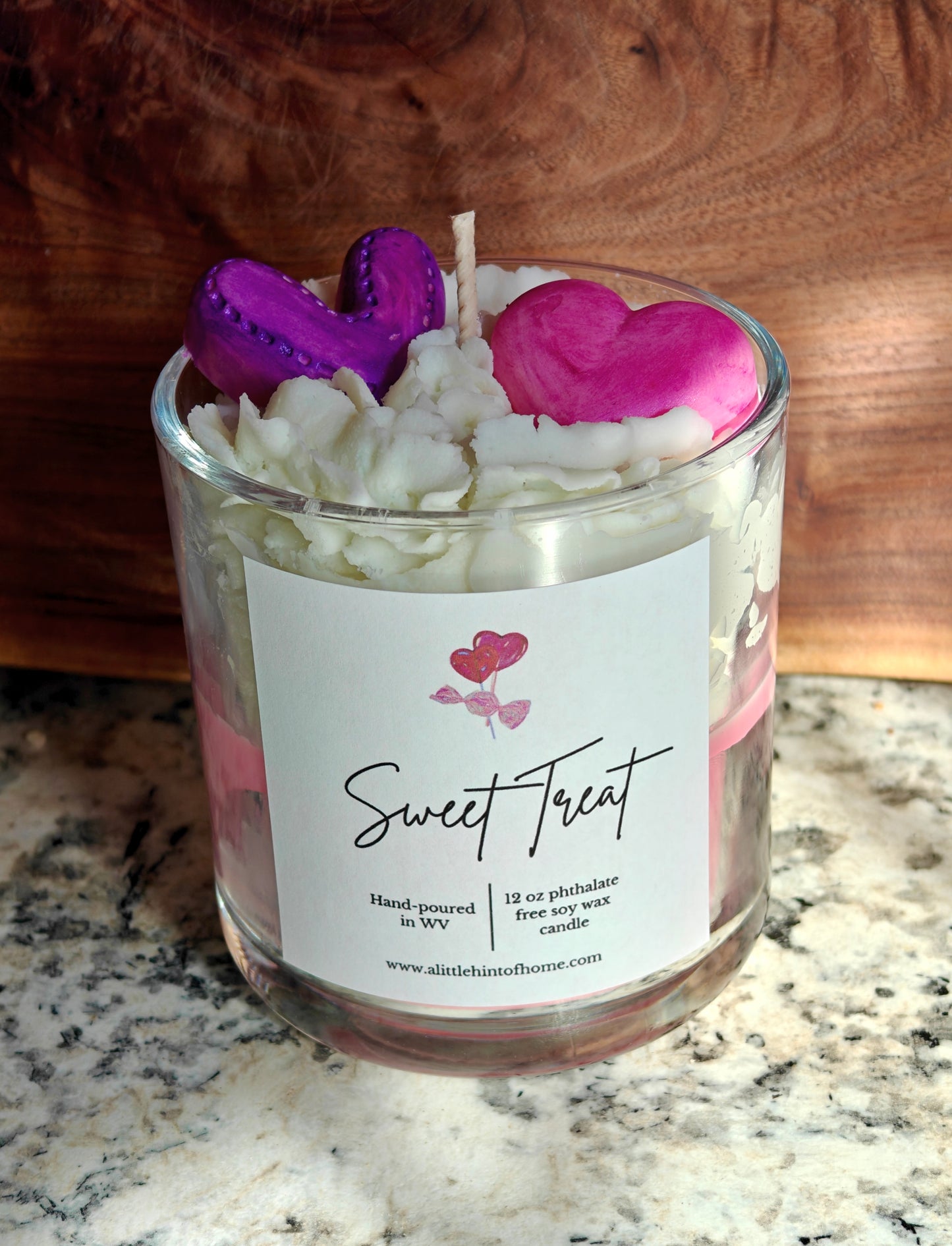 Candle in a glass jar with heart-shaped wax melts on top, labeled 'Sweet Treat'.