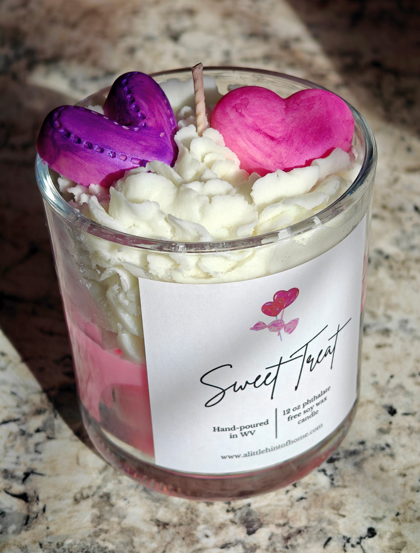 Candle in a glass jar with heart-shaped wax melts on top, labeled 'Sweet Treat'.