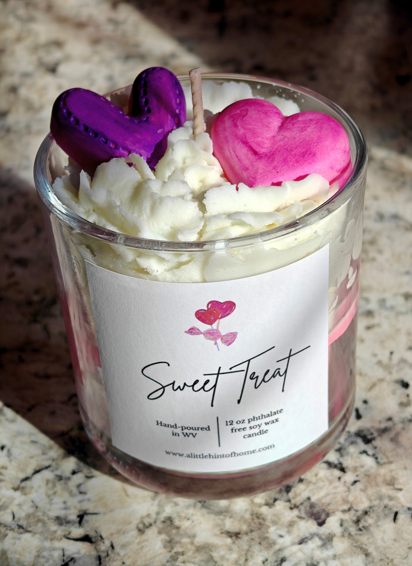 Candle in a glass jar with heart-shaped wax melts on top, labeled 'Sweet Treat'.