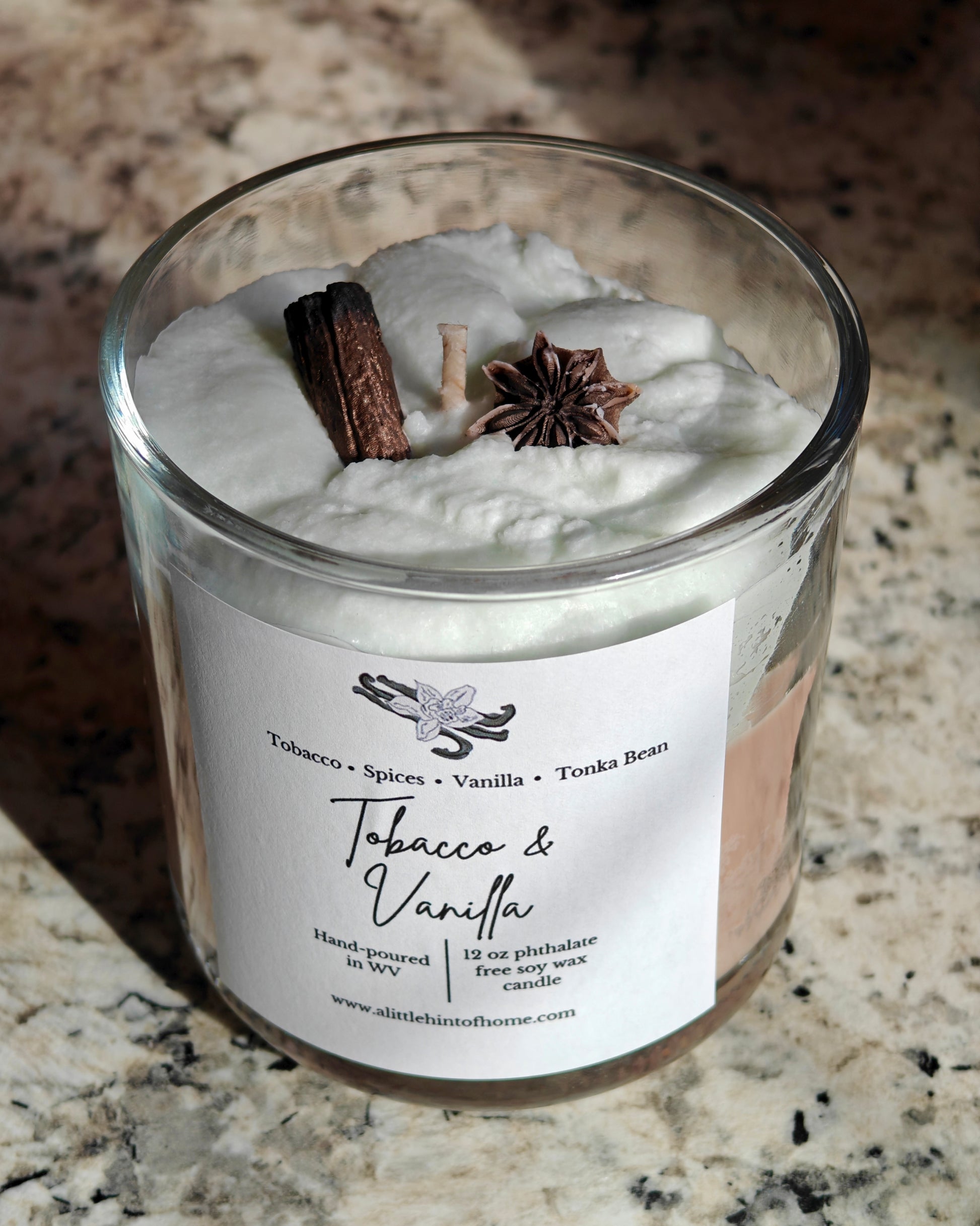 whipped soy candle with wax embeds on top with label stating tobacco and vanilla