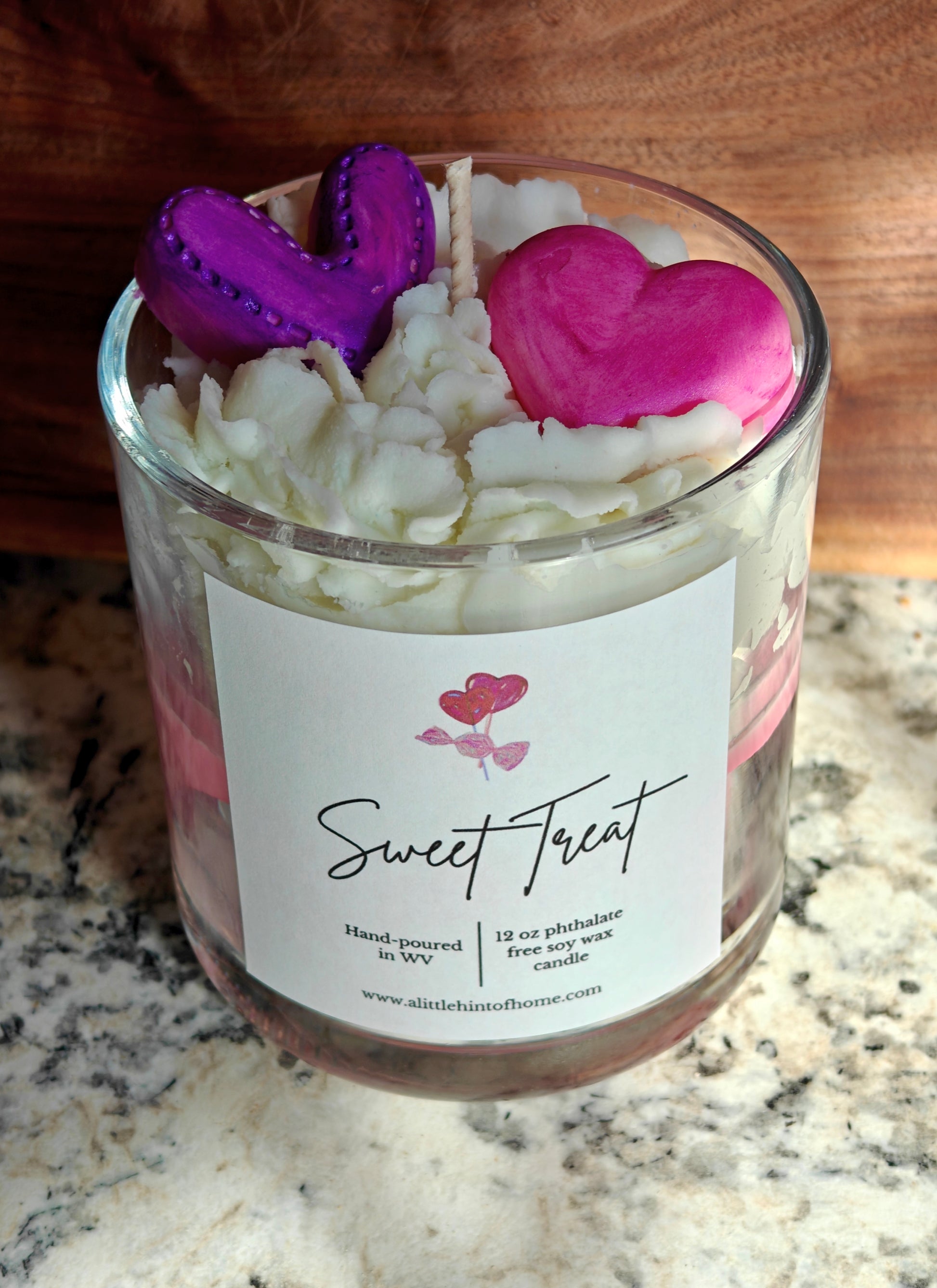 Candle in a glass jar with heart-shaped wax melts on top, labeled 'Sweet Treat'.